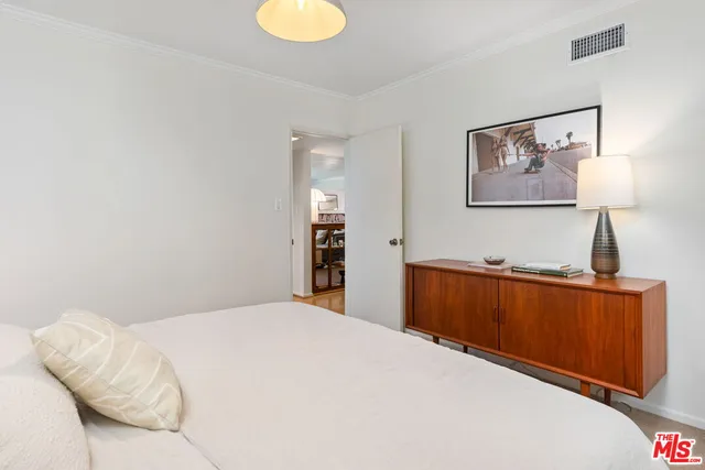 a bedroom with a bed and a lamp