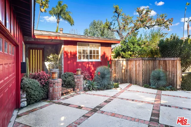 a view of a house with a backyard and garden
