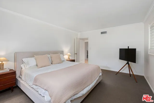 a bedroom with a bed and a chair