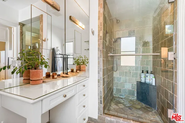 a view of a bathroom with a shower and a sink