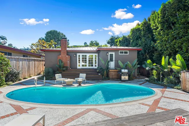 a front view of a house with garden and patio