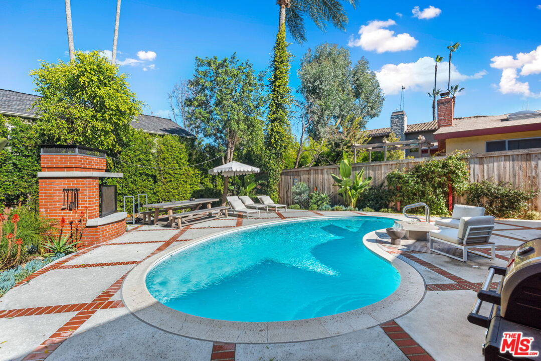 4247 Sespe Avenue Sherman Oaks, CA 91403 - Photo 26 of 31 a view of a swimming pool with outdoor seating