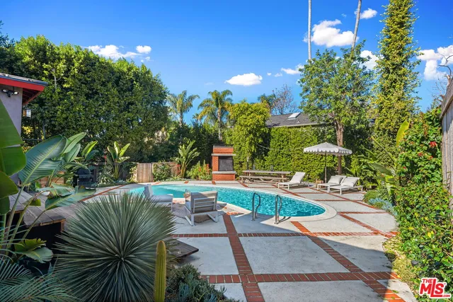 a view of a backyard with sitting area