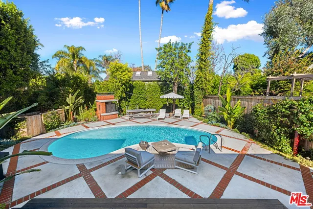 a backyard of a house with table and chairs