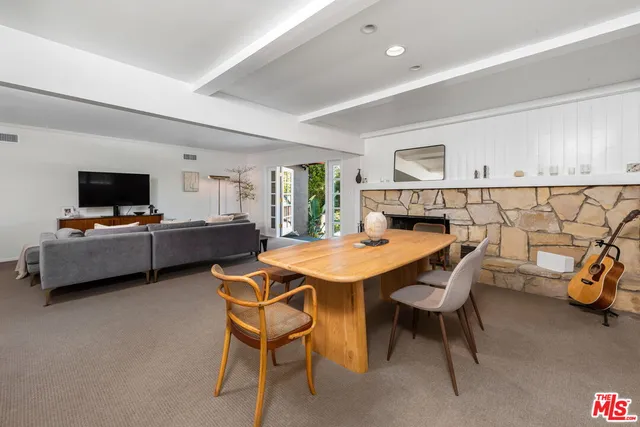 a view of a dining room with furniture and a flat screen tv