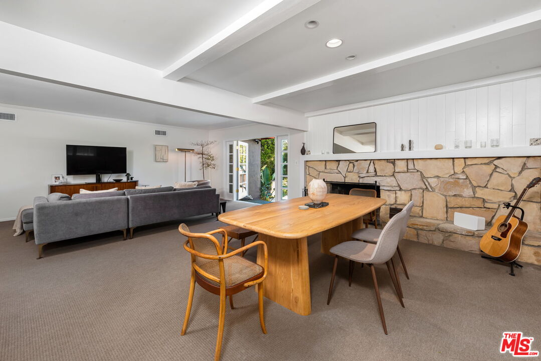 4247 Sespe Avenue Sherman Oaks, CA 91403 - Photo 9 of 31 a view of a dining room with furniture and a flat screen tv