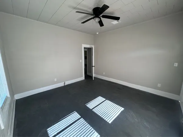 an empty room with wooden floor and closet