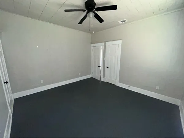 an empty room with wooden floor