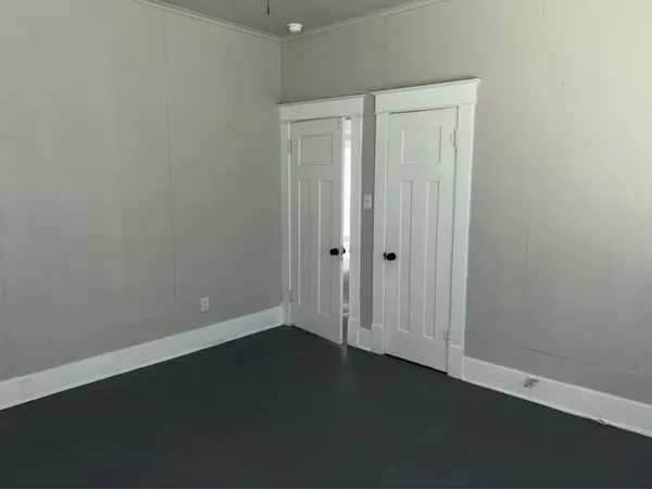 an empty room with a wooden door