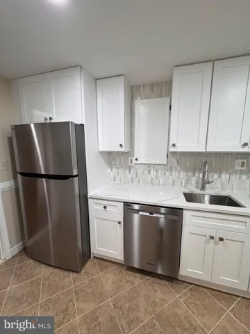 a kitchen with stainless steel appliances granite countertop a refrigerator sink and cabinets