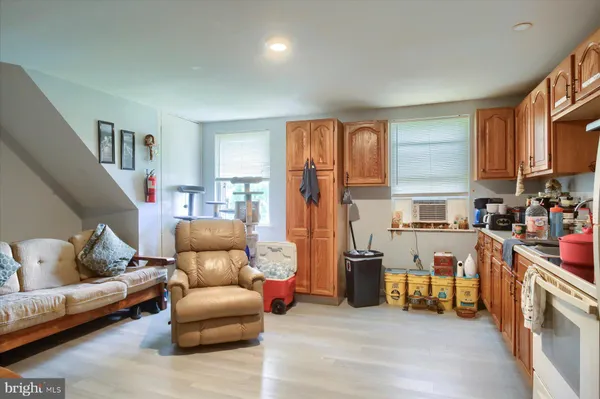a living room with furniture and a kitchen view