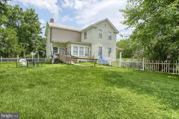 a view of a house with a yard and sitting area