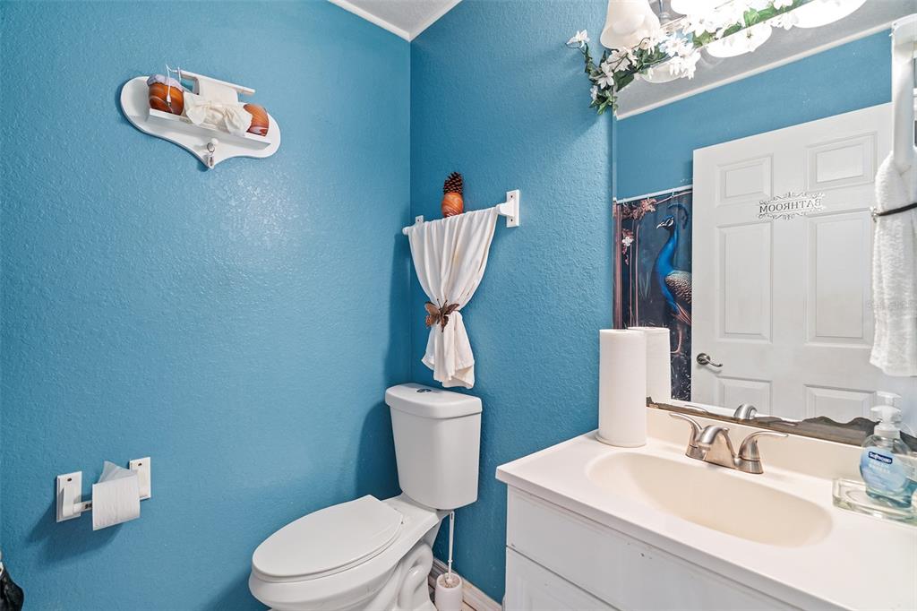 2830 Horton Road Kissimmee, FL 34744 - Photo 16 of 35 a bathroom with a toilet sink and mirror