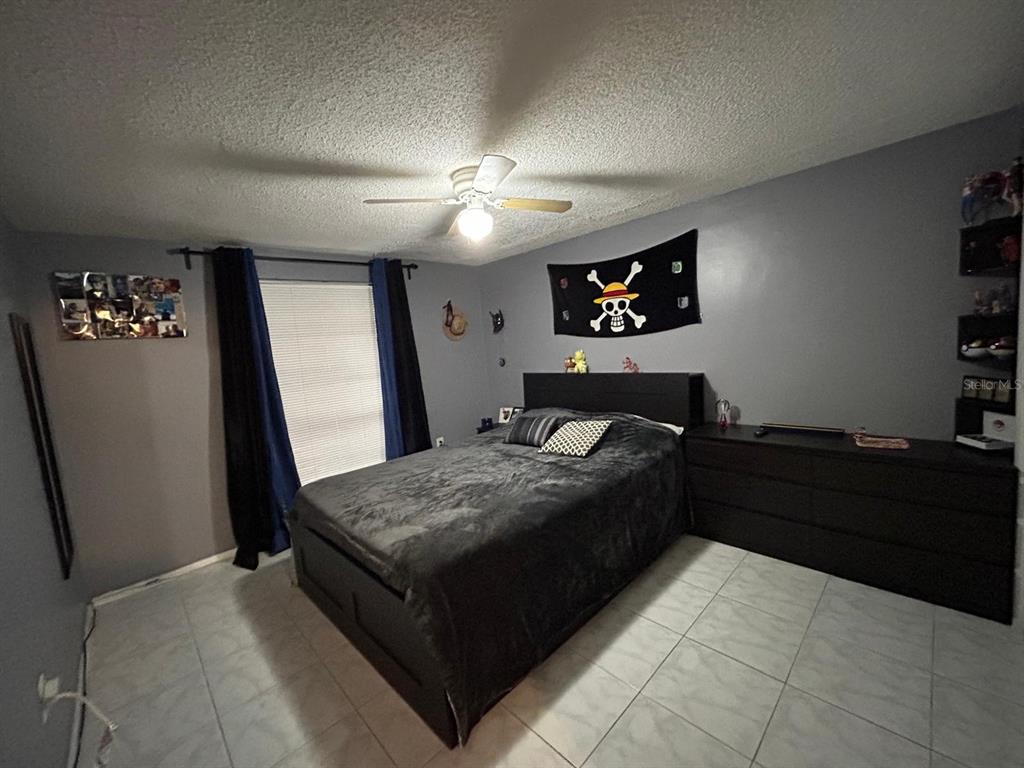 Undisclosed Address New Port Richey, FL 34652 - Photo 17 of 25 a bed room with a bed and a television