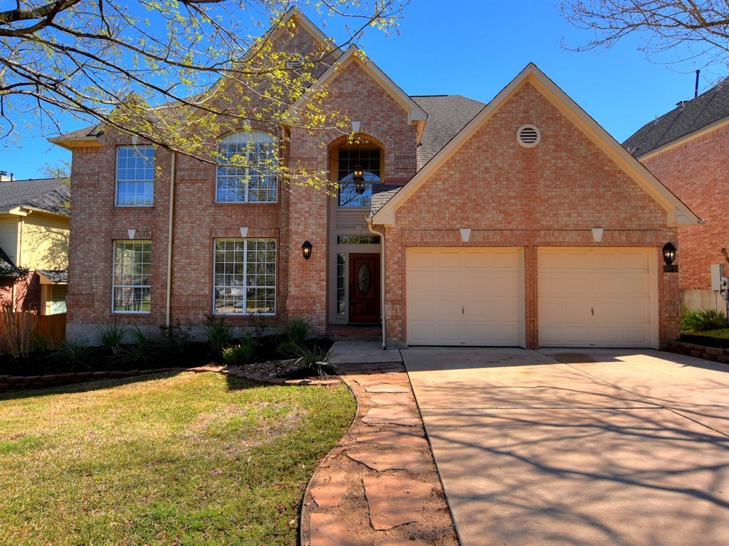 10725 Chestnut Ridge Road Austin, TX 78726 - Photo 1 of 1 a front view of a house with a yard