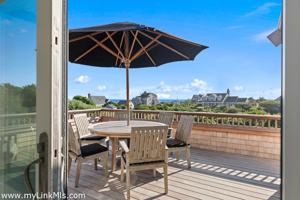 3 Tautemo Way Nantucket, MA 02554 - Photo 17 of 57 a view of a balcony with table and chairs