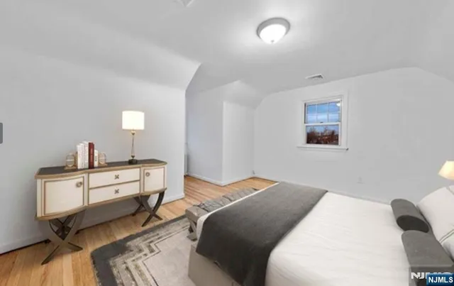 a bedroom with a bed and a dresser