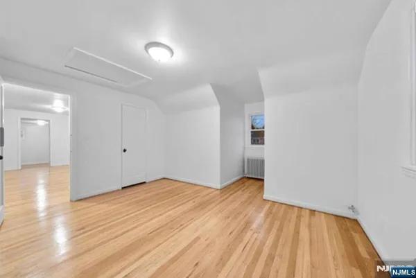 a view of an empty room and wooden floor