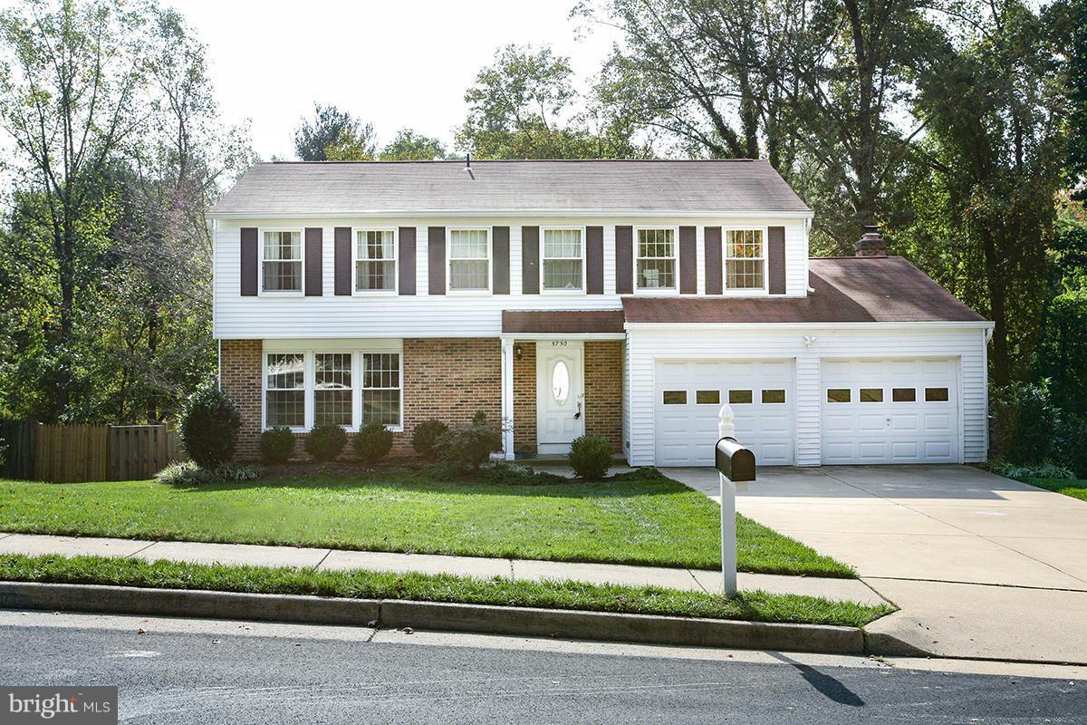 5750 Heming Avenue Springfield, VA 22151 - Photo 1 of 30 a front view of a house with a yard and garage