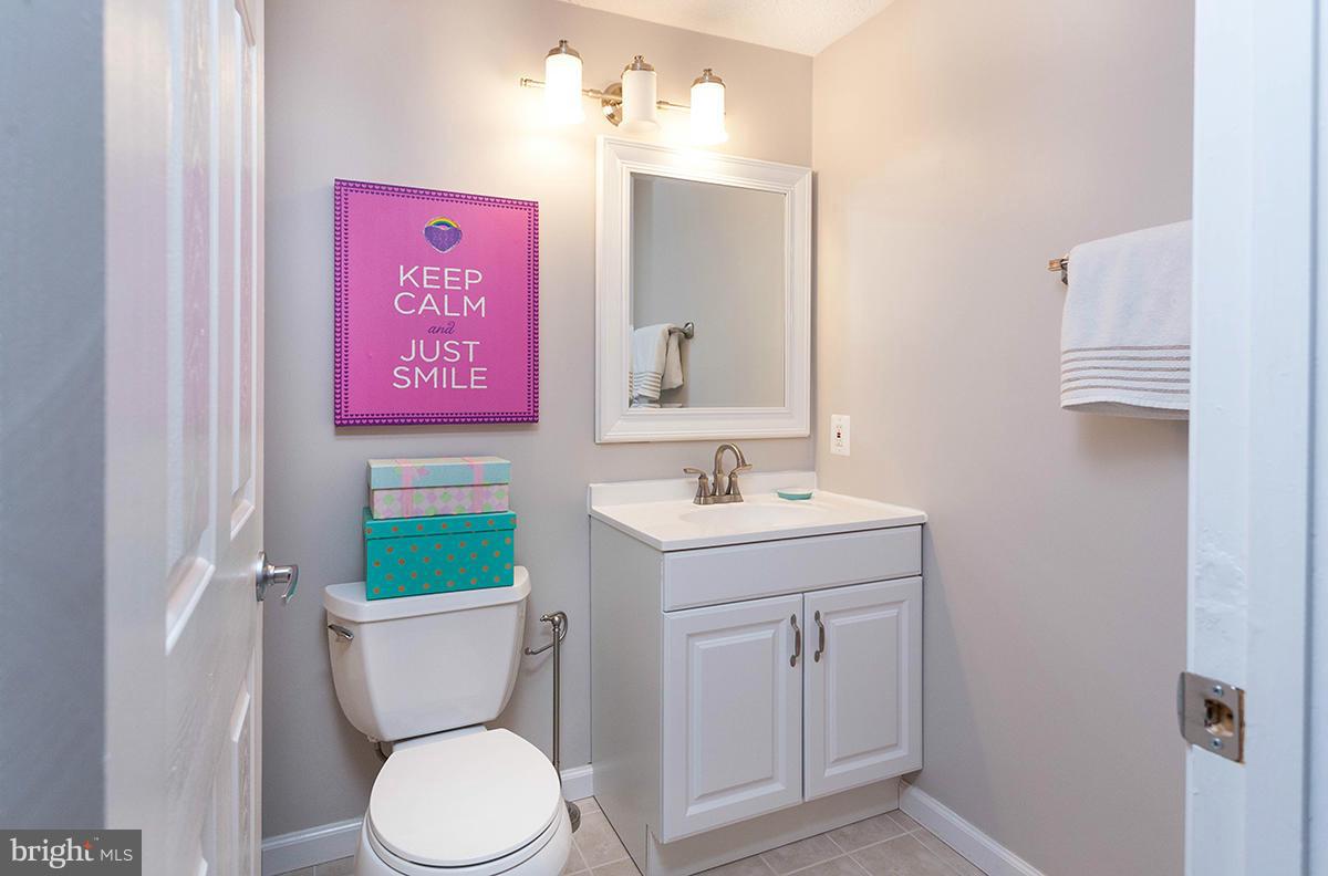 5750 Heming Avenue Springfield, VA 22151 - Photo 17 of 30 a bathroom with a toilet sink vanity and mirror