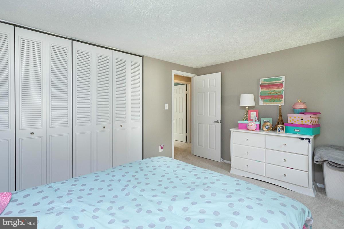 5750 Heming Avenue Springfield, VA 22151 - Photo 19 of 30 a bedroom with a bed and a dresser in it