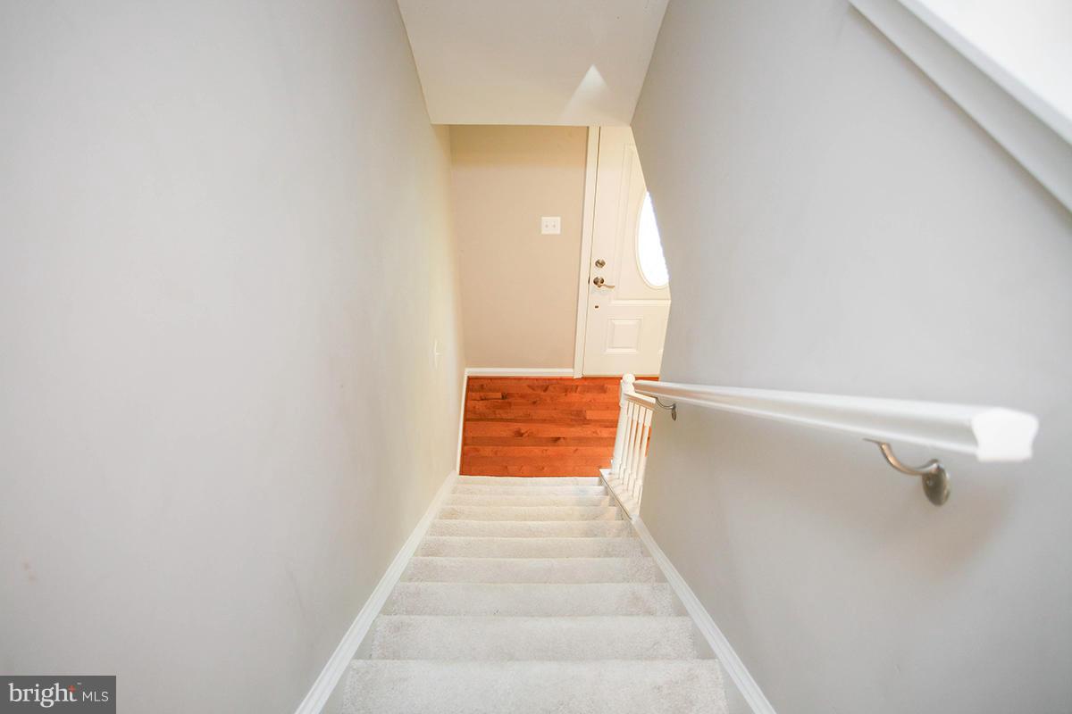 5750 Heming Avenue Springfield, VA 22151 - Photo 25 of 30 a view of a hallway with wooden floor and a white door