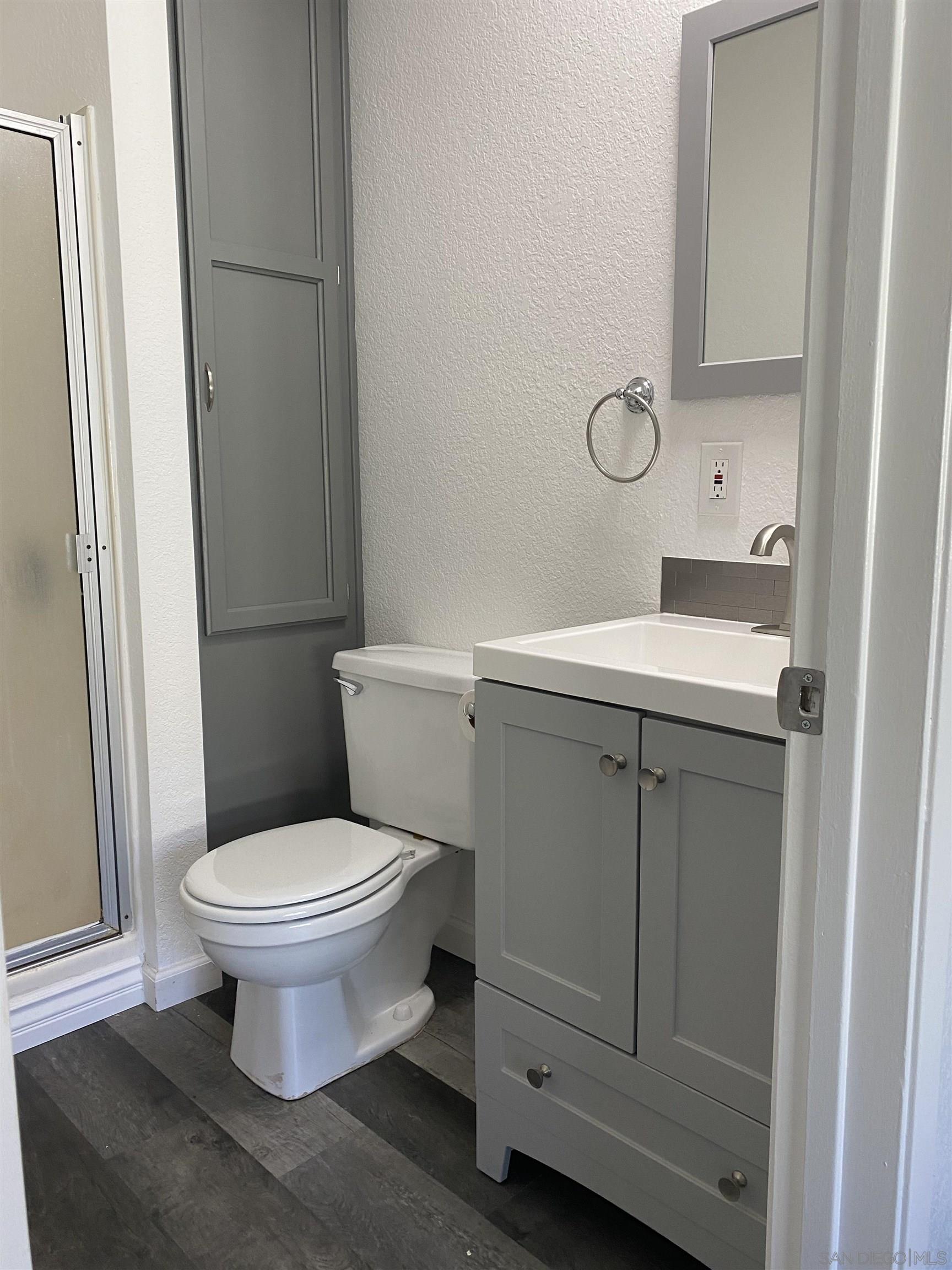 1122 Oro Street El Cajon, CA 92021 - Photo 6 of 8 a bathroom with a sink toilet and a mirror
