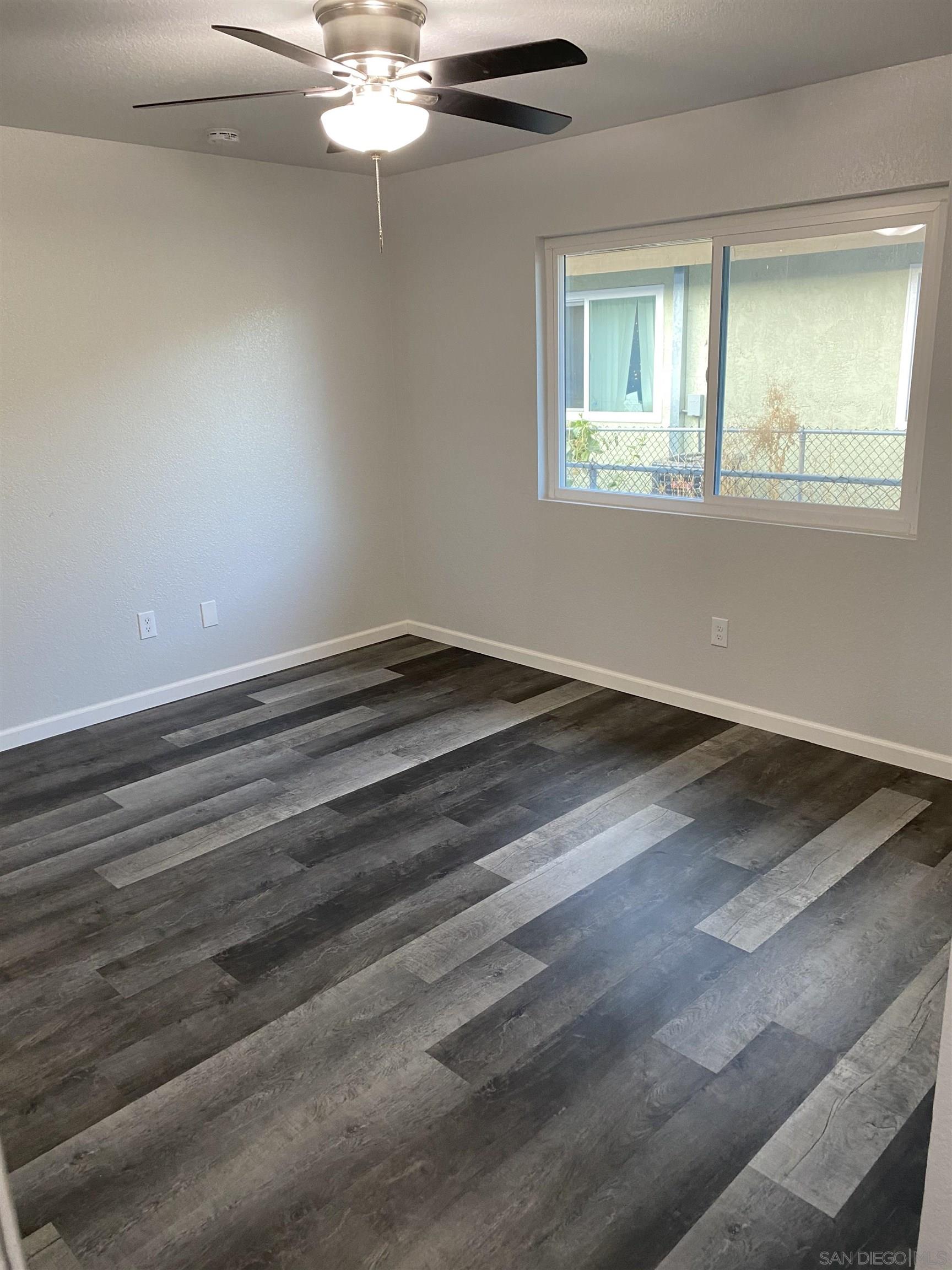 1122 Oro Street El Cajon, CA 92021 - Photo 7 of 8 wooden floor in an empty room with a window