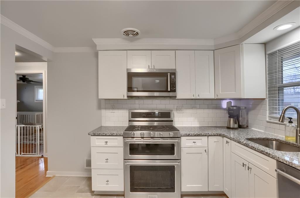445 Rockhill Road Pittsburgh, PA 15243 - Photo 11 of 31 a kitchen with white cabinets and appliances