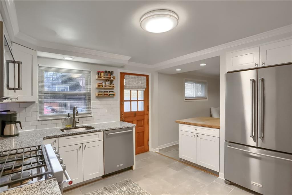 445 Rockhill Road Pittsburgh, PA 15243 - Photo 12 of 31 a kitchen with a refrigerator sink and white cabinets