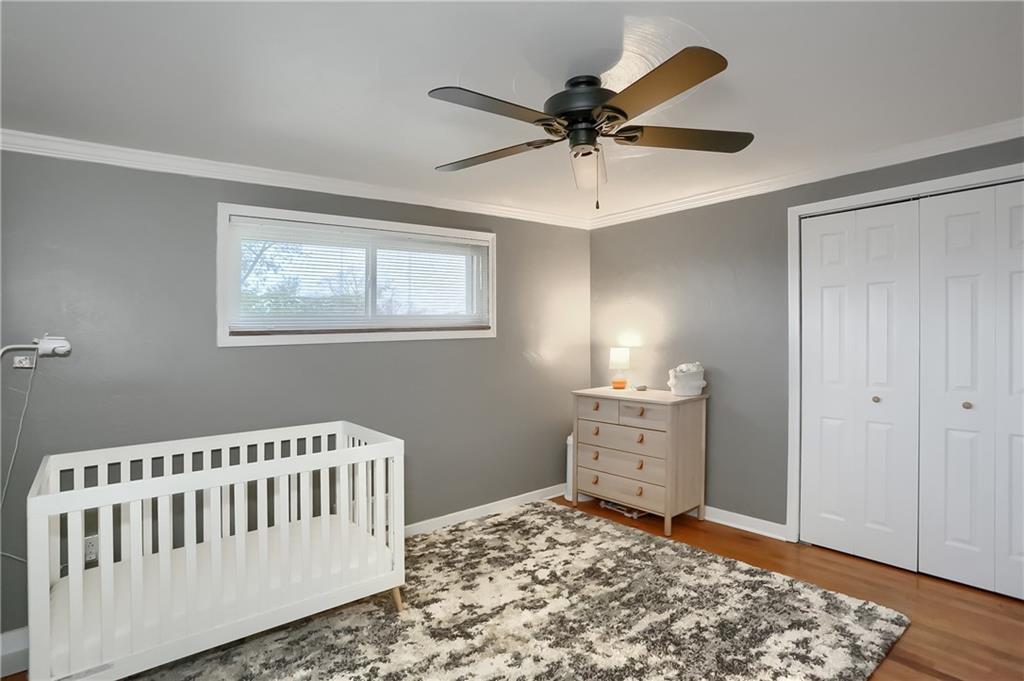 445 Rockhill Road Pittsburgh, PA 15243 - Photo 21 of 31 a bedroom with a bed and wooden floor