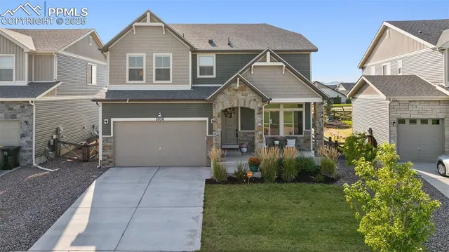 a view of a white house next to a yard