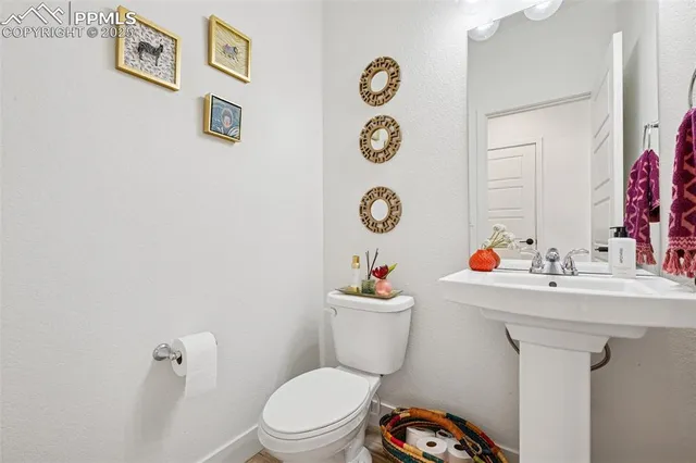 a bathroom with a sink mirror vanity and toilet