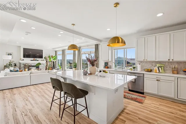 a kitchen with counter top space appliances and a living room view