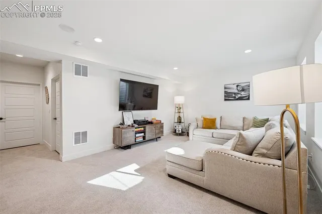 a very nice looking room with a gaming machine and a chandelier
