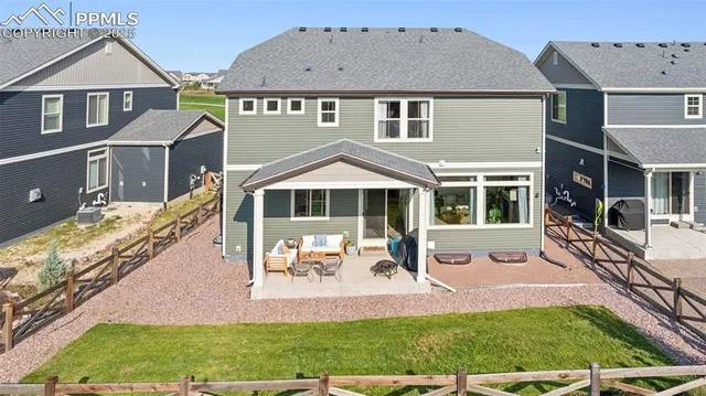 an aerial view of a house with a yard