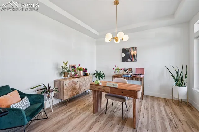 a view of a dining room with furniture wooden floor and a chandelier