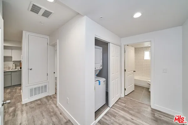 a view of a kitchen with a sink and a refrigerator