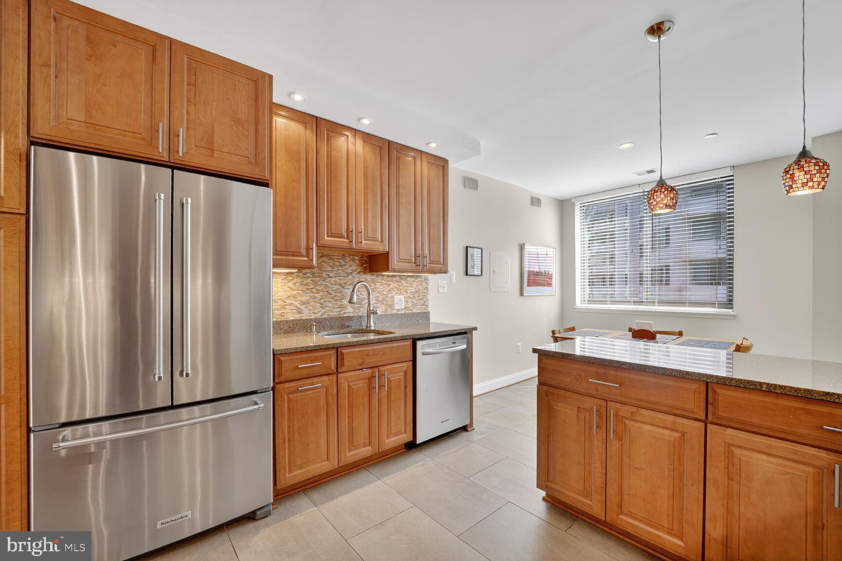 4550 North Park Avenue, Unit 1005 Chevy Chase, MD 20815 - Photo 15 of 30 a kitchen with stainless steel appliances granite countertop a refrigerator sink and cabinets