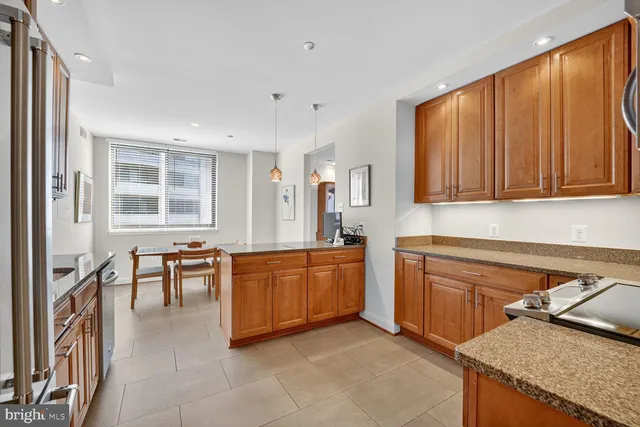 a kitchen with stainless steel appliances granite countertop sink stove top oven and cabinets