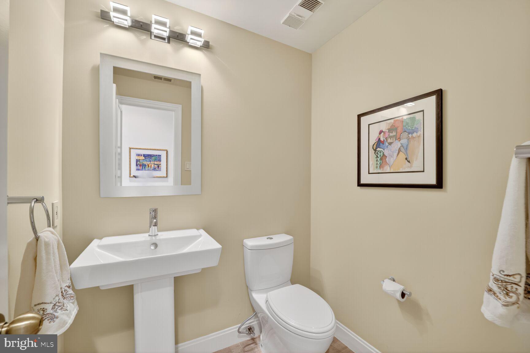 4550 North Park Avenue, Unit 1005 Chevy Chase, MD 20815 - Photo 17 of 30 a bathroom with a toilet a sink and mirror