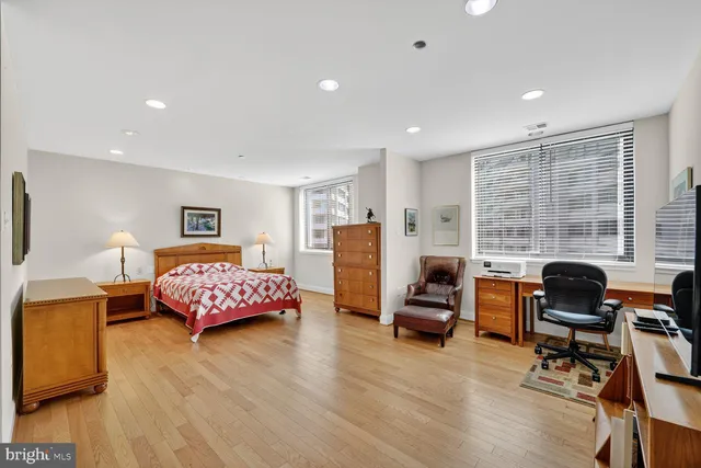 a bedroom with a bed and wooden floor