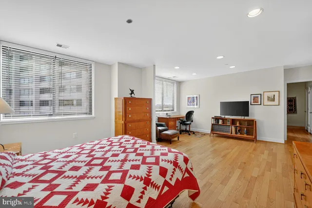 a bedroom with furniture and a flat screen tv
