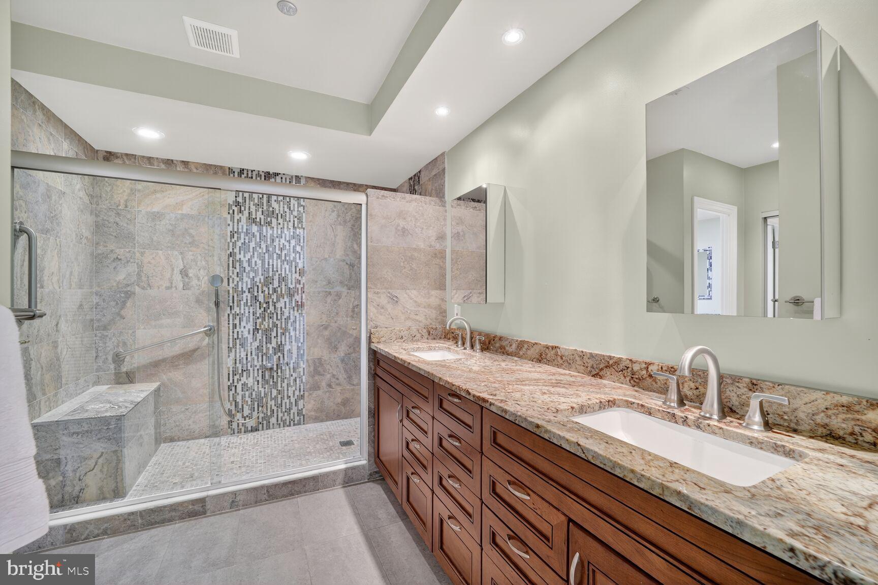 4550 North Park Avenue, Unit 1005 Chevy Chase, MD 20815 - Photo 23 of 30 a bathroom with a granite countertop double vanity sink and shower