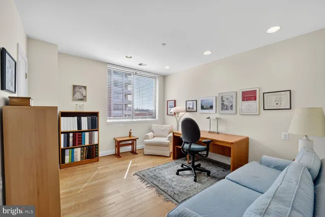 a living room with furniture and a bookshelf
