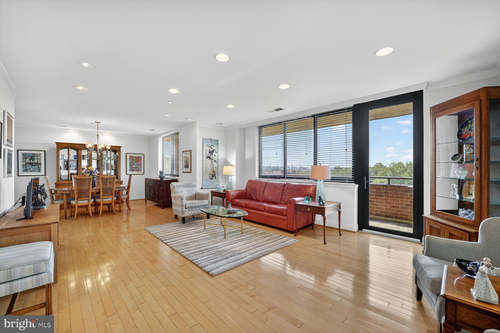 4550 North Park Avenue, Unit 1005 Chevy Chase, MD 20815 - Photo 3 of 30 a living room with furniture and large windows