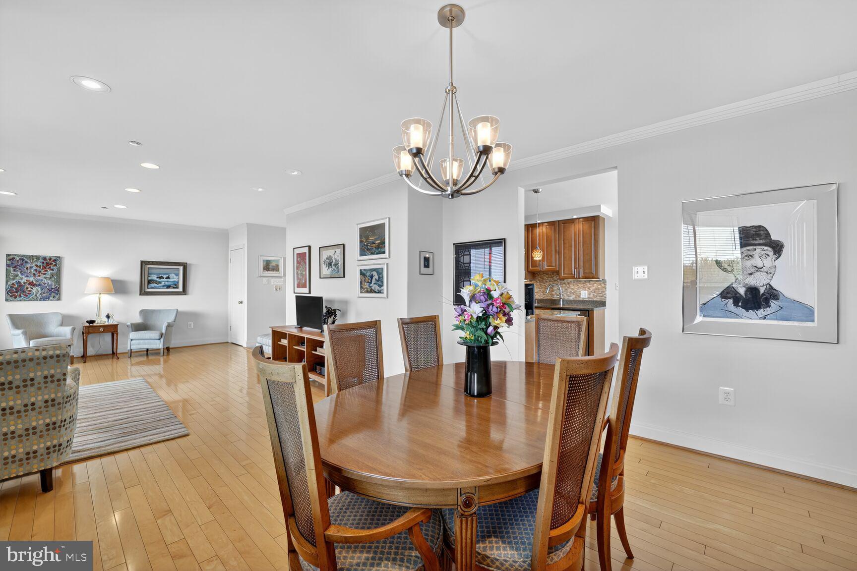 4550 North Park Avenue, Unit 1005 Chevy Chase, MD 20815 - Photo 9 of 30 a view of a dining room with furniture and wooden floor