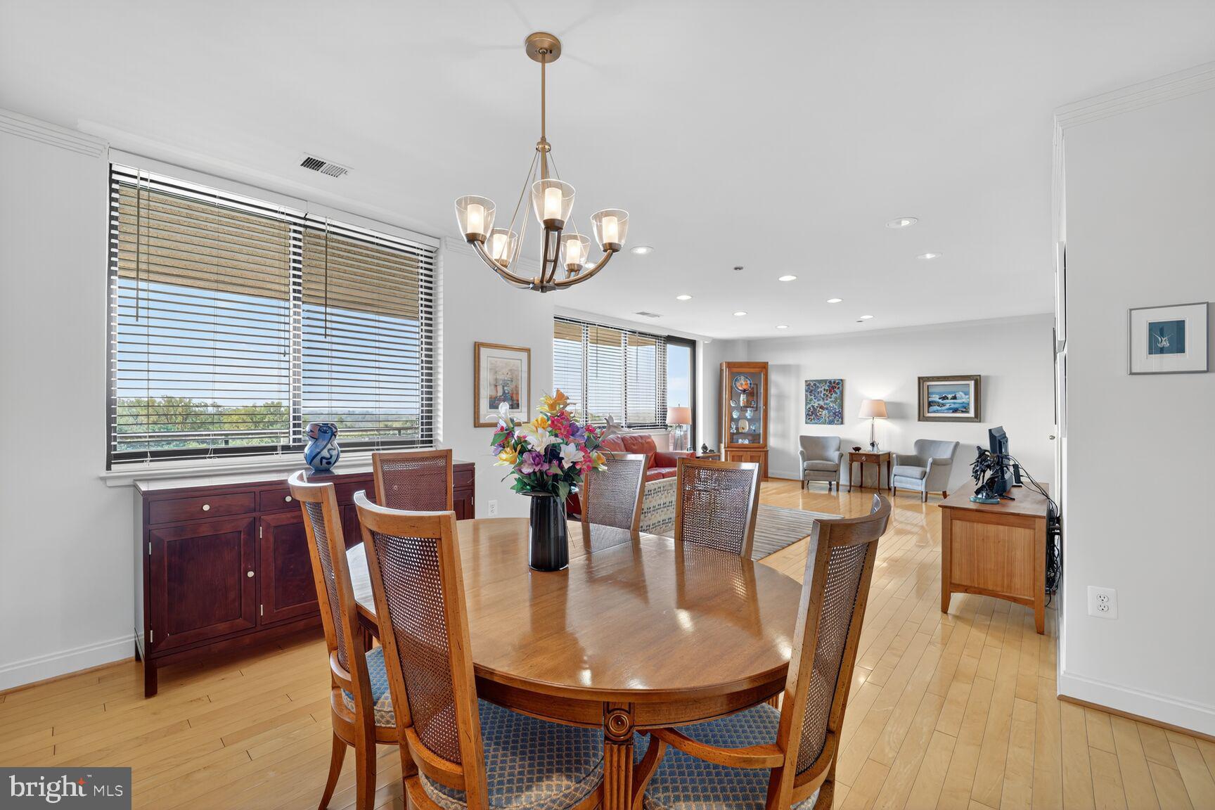 4550 North Park Avenue, Unit 1005 Chevy Chase, MD 20815 - Photo 10 of 30 a view of a dining room with furniture window and wooden floor