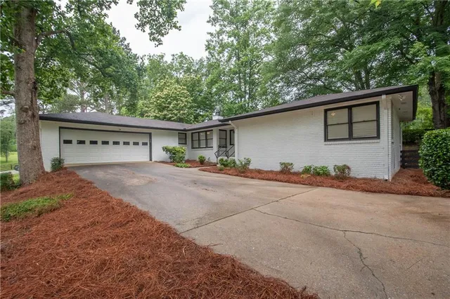 a view of house with outdoor space and parking