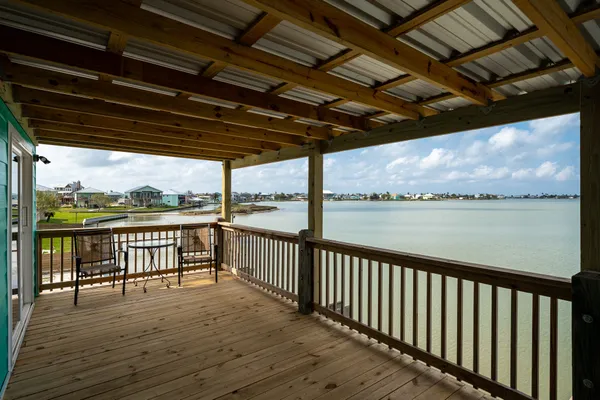 a view of a balcony with wooden floor